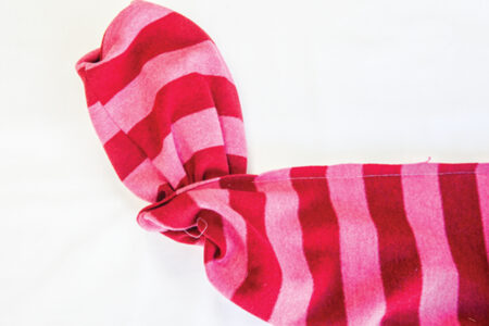 sewn red and pink striped fabric turned partially inside out